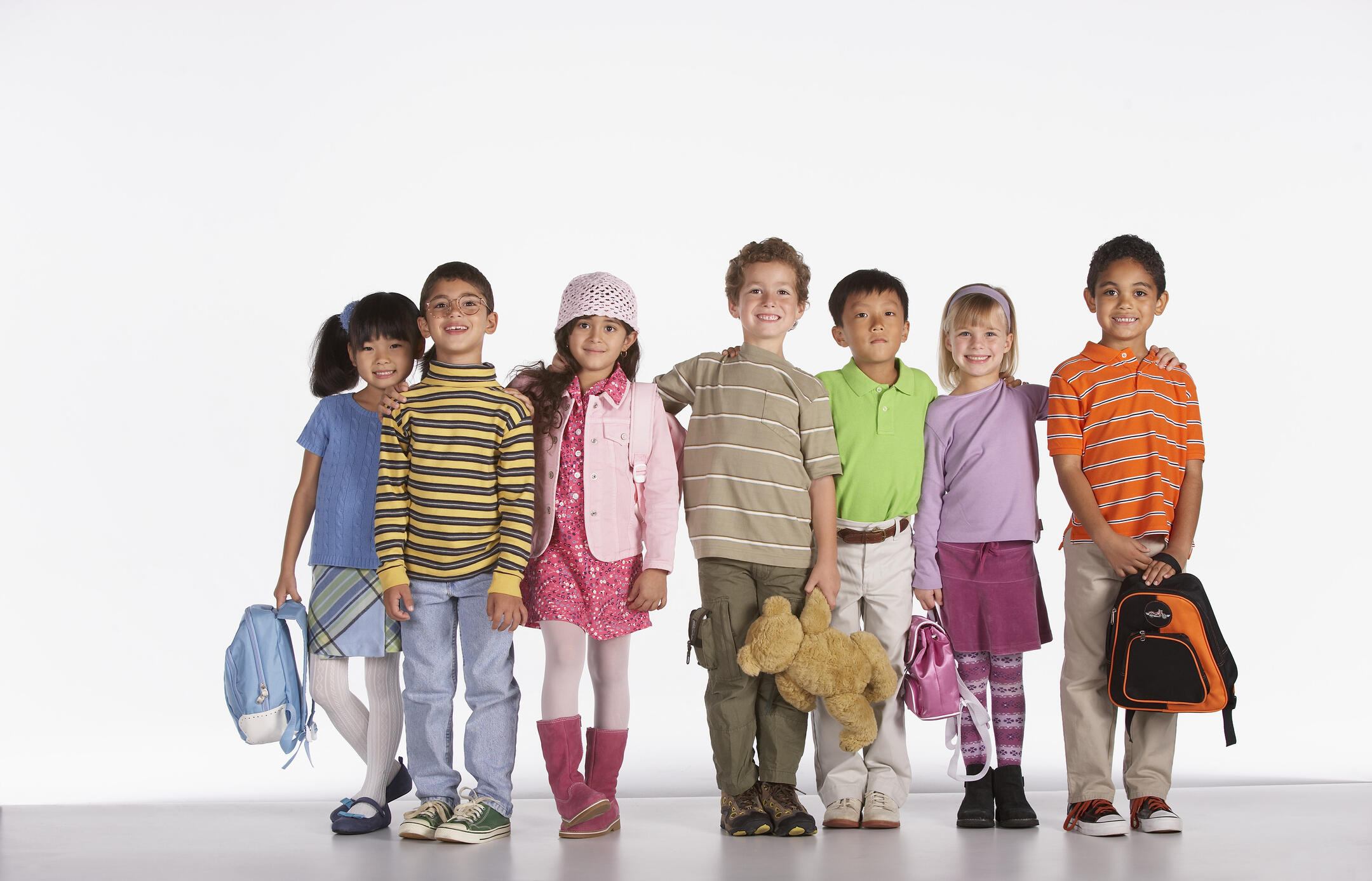 Kids standing in a row and ready for school.