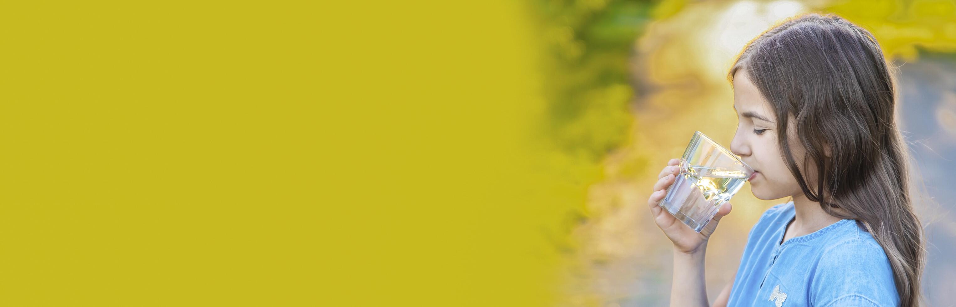 Girl drinking a glass of water. 
