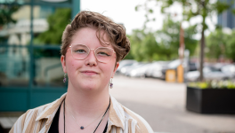 portrait of teen outside with glasses smiling