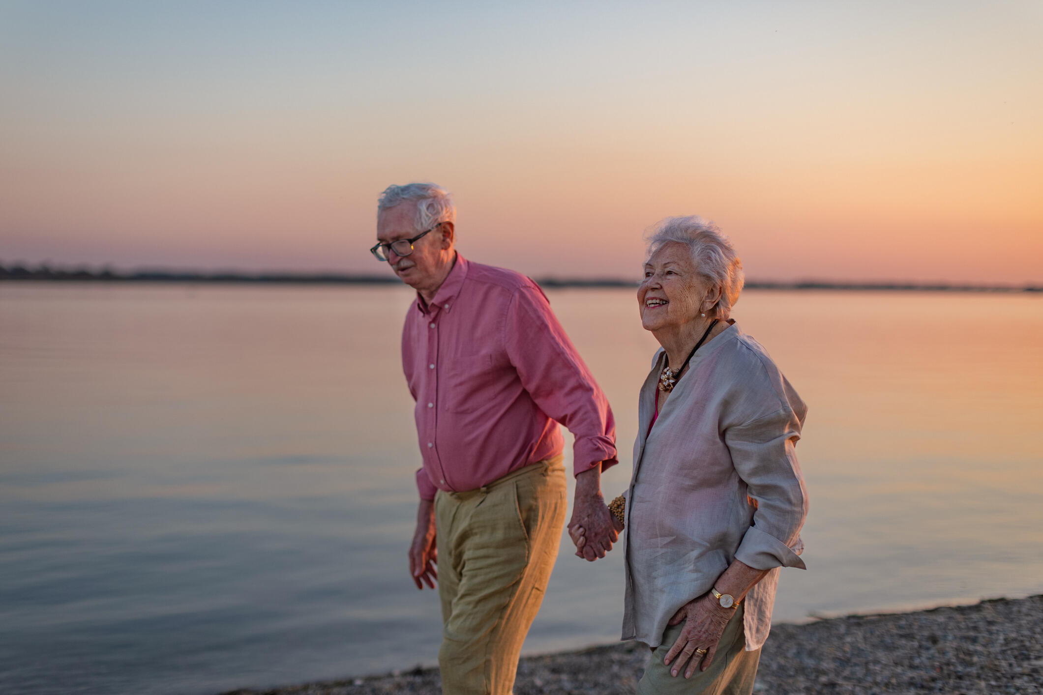 older couple walking by lake