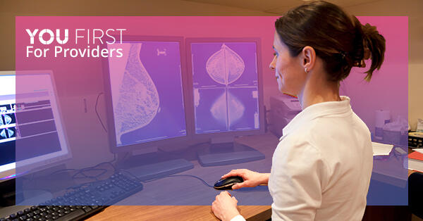 Health care provider reviewing mammogram images on computer screen, with You First logo
