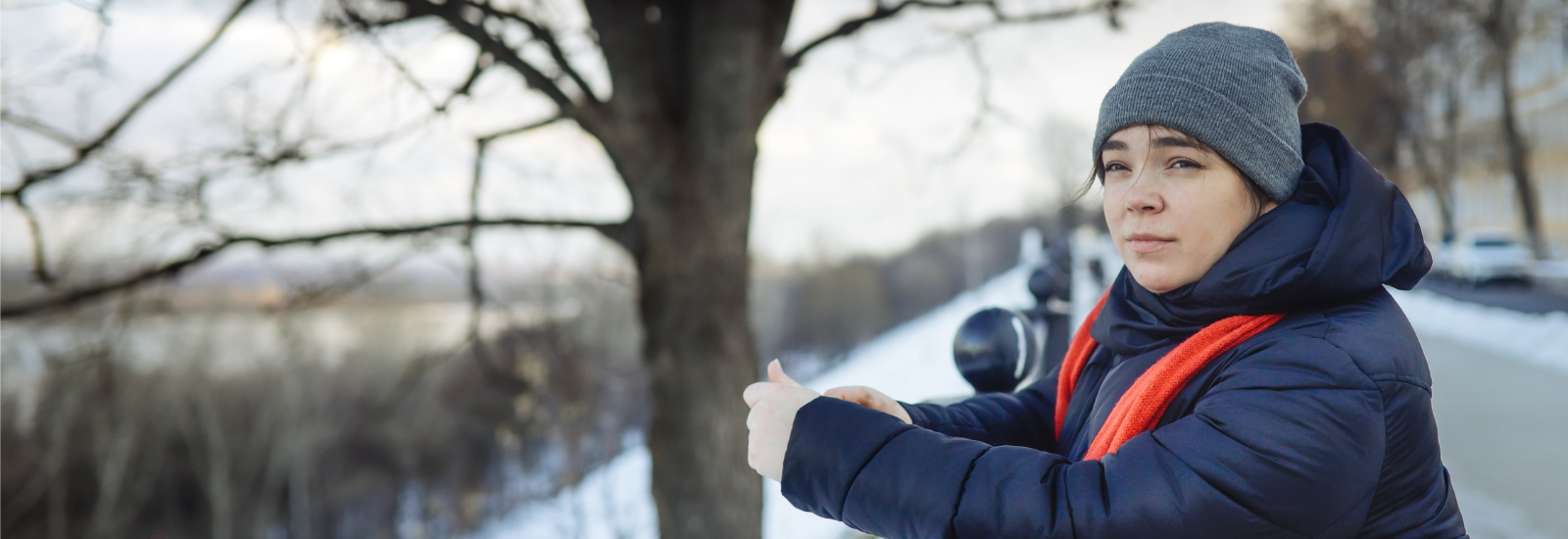 Person standing outside in winter.