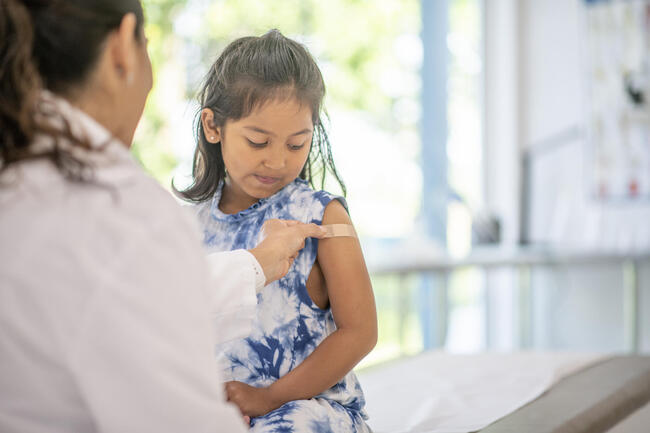 child getting immunization placed on arm