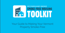 The cover page of the Smoke free Housing Toolkit with a blue background and graphic of a house and apartment building in front of mountains.